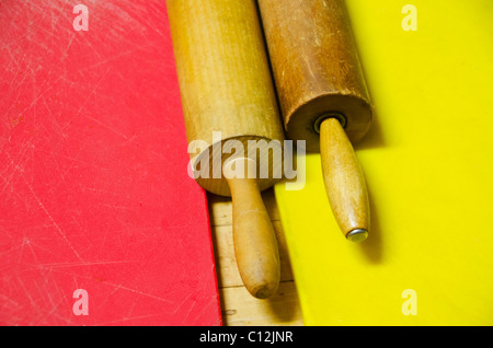 Two rolling pins on chopping boards Stock Photo