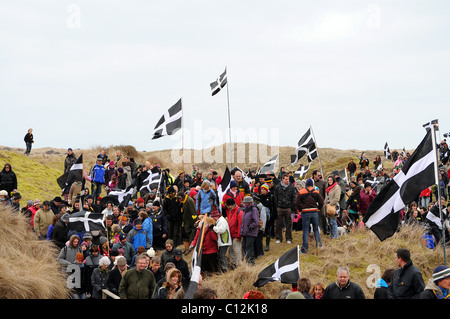 Cornish people marching through the dunes at Perranporth,Cornwall,UK, during the annual St.Pirans day celebrations Stock Photo
