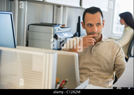 USA, New Jersey, Jersey City, business man working in office Stock Photo