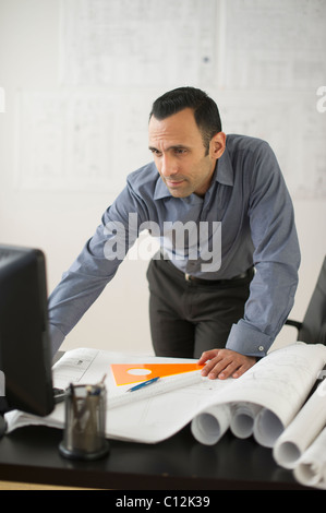 USA, New Jersey, Jersey City, business man studying blueprints Stock Photo