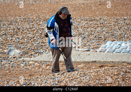 Man On A Beach With A Metal Detector Stock Photo