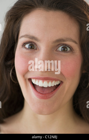 Studio shot of young happy beautiful Asian woman smiling while h Stock ...