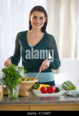 USA, New Jersey, Jersey City, Young attractive woman preparing food Stock Photo