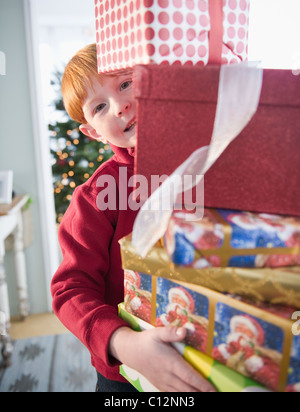 USA, New Jersey, Jersey City, Portrait of boy (8-9) carrying Christmas gifts Stock Photo