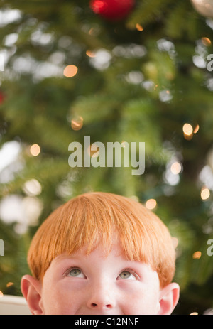 USA, New Jersey, Jersey City, Boy (8-9) by Christmas tree Stock Photo