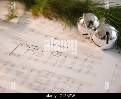 USA, New Jersey, Jersey City, Christmas baubles on carol music sheet Stock Photo