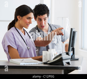 USA, New Jersey, Jersey City, Young doctors working on computer Stock Photo