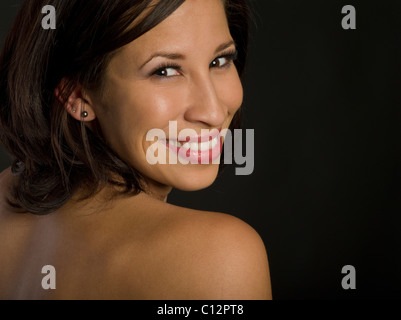 Beautiful woman looking over her shoulder into the camera Stock Photo