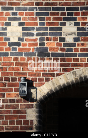 Detail of Victorian patterned brickwork and lamp on the stable block within Saltwell Park, Gateshead, England Stock Photo