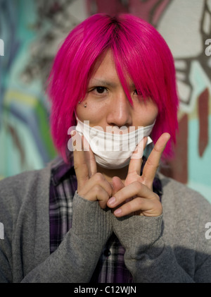 Young Japanese Man in the trendy America-mura district of Osaka, Japan Stock Photo