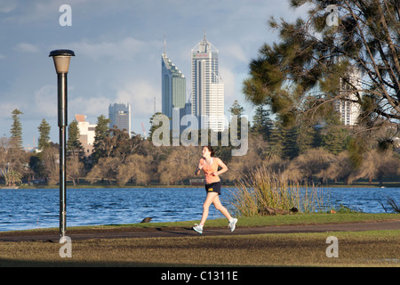 Young woman jogging in a city park. Stock Photo