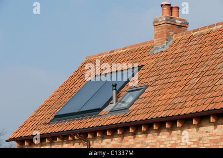 Integrated thermal solar panel on the roof of a newly built house to produce hot water Stock Photo
