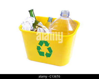 Yellow plastic garbage bin with green recycle symbol containing empty plastic bottles, beer cans, paper and color glass bottle o Stock Photo