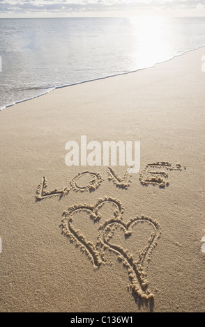 USA, Massachusetts, love sign with heart shapes on sand Stock Photo