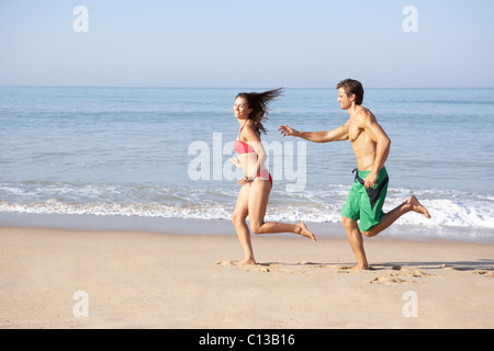 Young couple running on beach Stock Photo
