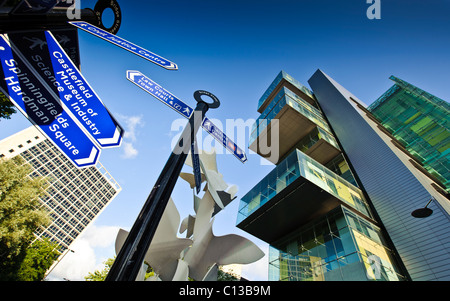 Manchester civil justice centre law courts wide angle shot with street signs in foreground bright sunny day blue sky Stock Photo
