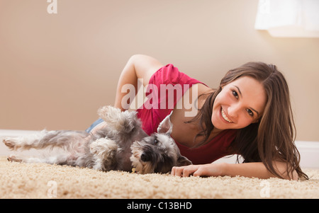 USA, Utah, Lehi, Young woman playing with schnauzer Stock Photo