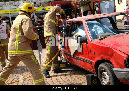 East Sussex  fire and rescue team use a hydraulic cutter to free an injured casualty from a car during an training exercise Stock Photo