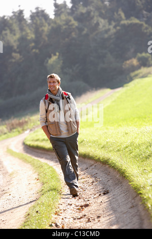Young man walks in park Stock Photo