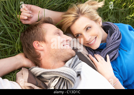 Young couple lying together on grass Stock Photo