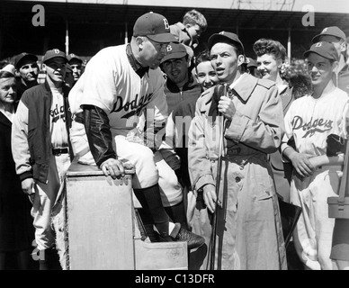 Frank Sinatra sings at a Brooklyn Dodgers game that is a benefit for the 1944 Red Cross War Fund. At his left is Dodger Charley Stock Photo