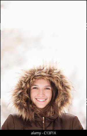 USA, Utah, Lehi, Portrait of young woman wearing fur hooded coat Stock Photo
