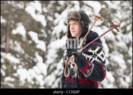 USA, Utah, Salt Lake City, man carrying ski poles Stock Photo