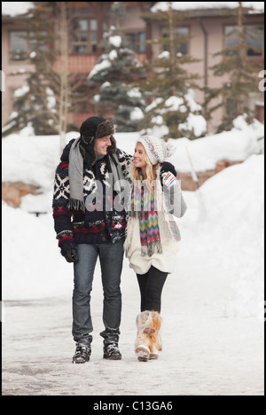USA, Utah, Salt Lake City, couple walking in snowy village Stock Photo