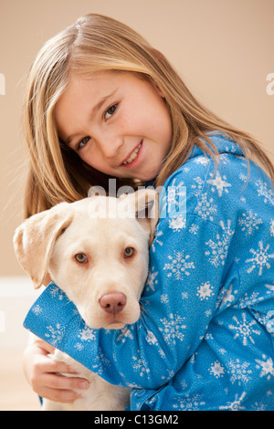 USA, Utah, Lehi, Portrait of girl (10-11) embracing Labrador Stock Photo