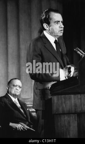 1971 US Presidency. FBI Director J. Edgar Hoover (background) watches as President Richard Nixon delivers speech at the FBI National Academy graduation exercises, Washington, D.C., 1971. Stock Photo