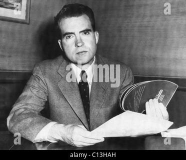 Richard Nixon. Senator and Republican Vice Presidential candidate (and future US President) Richard Nixon holding a copy of Democratic presidential candidate Adlai Stevenson's deposition on the Alger Hiss case, during a radio and television address, New York City, 1952. Stock Photo