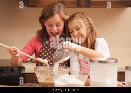 USA, Utah, Lehi, Two girls (10-11) baking in kitchen Stock Photo
