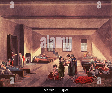 Detention room in London's Bridewell Hospital, for homeless, impoverished, and probably single or unwed mothers. British Poor Law required paupers be returned to their rural parishes, who were responsible for the local care of the poor. Before return, the women paupers and their children were detained in low stalls with hay for bedding. Drawing by Thomas Rowlandson and Augustus Pugin, ca. 1808. Stock Photo