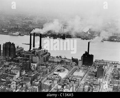 Smoke issues from stacks of Con Edison's coal powered electricity generating plant on the East River. New York City, February 15, 1951. Stock Photo