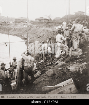 Panama Canal construction showing workers loading holes with dynamite, at Point 2 on June 6, 1909. Note the name of the American corporation, 'DuPont,' in the wooden crates. Stock Photo