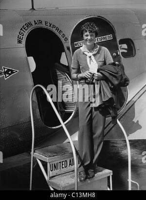 Amelia Earhart 1897-1937 standing in the door of a Western Airlines planes in California as she embarks to New York to make her Stock Photo