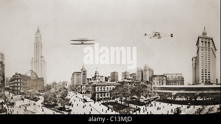 Wide angle panorama with two airplanes in flight over downtown Manhattan. At left are the Custom House and Woolworth Building in center is City Hall and at left Park Place. 1913 photograph by Irving Underhill. LC-USZ62-137785 Stock Photo