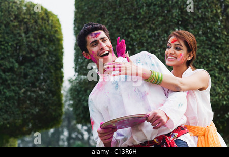 Couple celebrating Holi Stock Photo