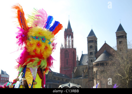 Carnival crowd at Vrijthof square with Red Tower of Protestant St Johns Church and Catholic St Servatius church Maastricht Stock Photo