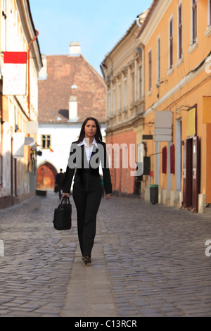 young businesswoman walking on street in urban city Stock Photo - Alamy