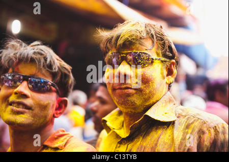 Men covered with powder paint during Holi festival, Barsana, Uttar Pradesh, India Stock Photo