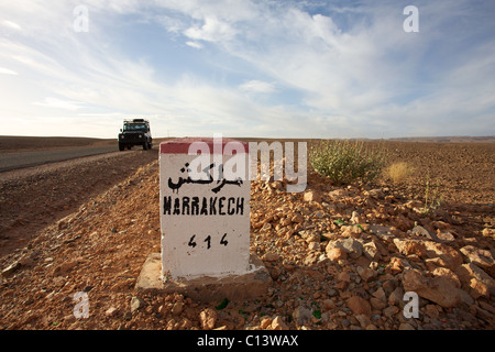 Road Sign to Marrakech in Morocco with blue sky Stock Photo