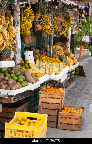 Open air fruit market in Tulum. Ripe fruit spills out onto the sidewalk from this small fresh fruit vendor's store. Stock Photo