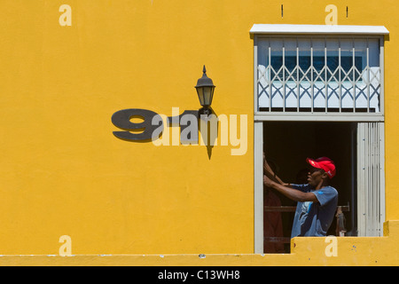 House painter at work, Bo Kaap, Cape Town, South Africa Stock Photo