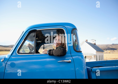 USA, Colorado, Carbondale, Cowgirl driving old fashioned pickup truck Stock Photo