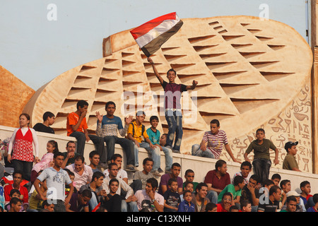 A boy waves an Egyptian flag and other spectators watch the warmups prior to the FIFA U-20 World Cup 3rd and 1st place matches. Stock Photo