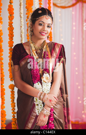 Portrait of a bride wearing a garland and smiling Stock Photo
