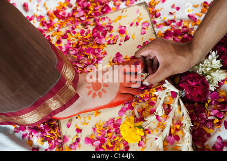 Bridegroom putting a toe ring onto the bride's toe during South Indian  wedding ceremony, Stock Photo, Picture And Rights Managed Image. Pic.  PNM-PIRM-20100508-SA0907 | agefotostock