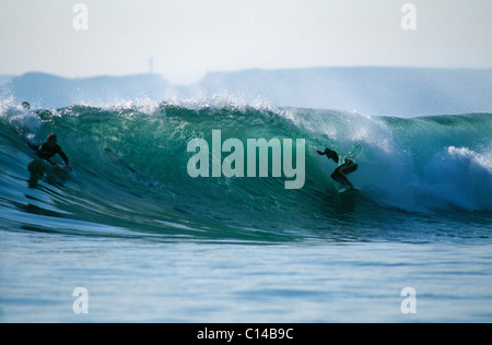 Surfing in UK.  Tube ride on Gower, Wales. Stock Photo