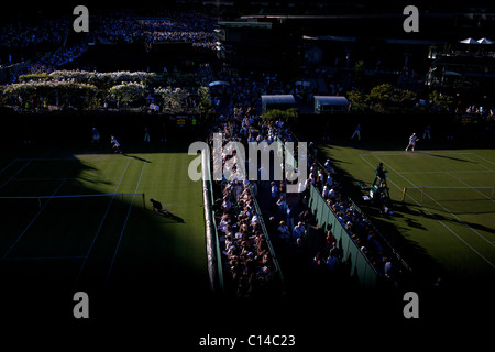 The late afternoon light descends on the outside courts during the All England Lawn Tennis Championships, Wimbledon. England. Stock Photo